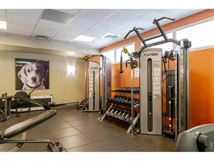 a living room with furniture and a dining table