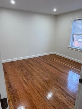 an empty room with wooden floor