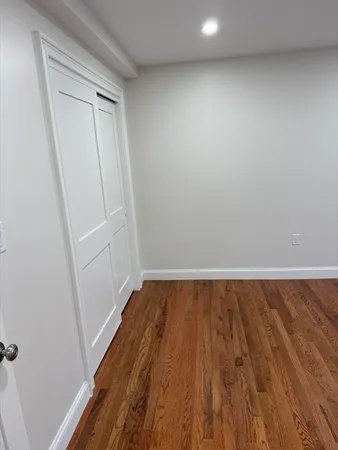 a view of a room with wooden floor