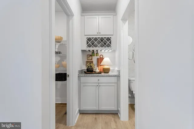 a kitchen with white cabinets and appliances