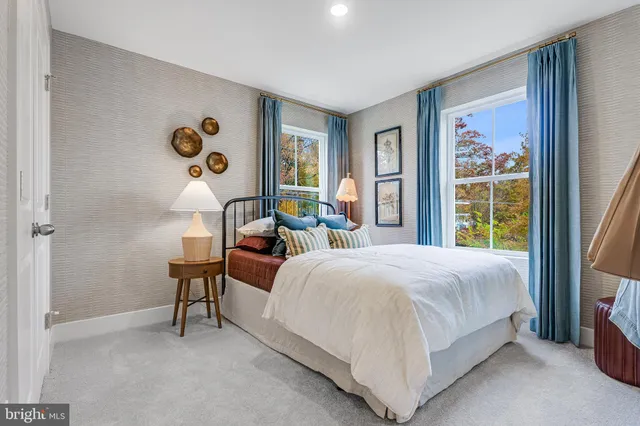 a bedroom with bed and a potted plant