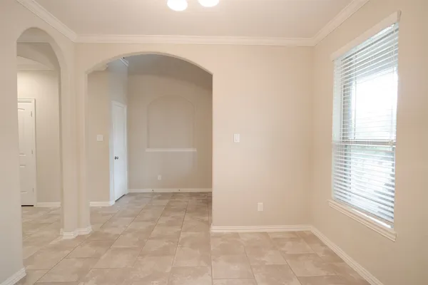 an empty room with closet and a chandelier fan