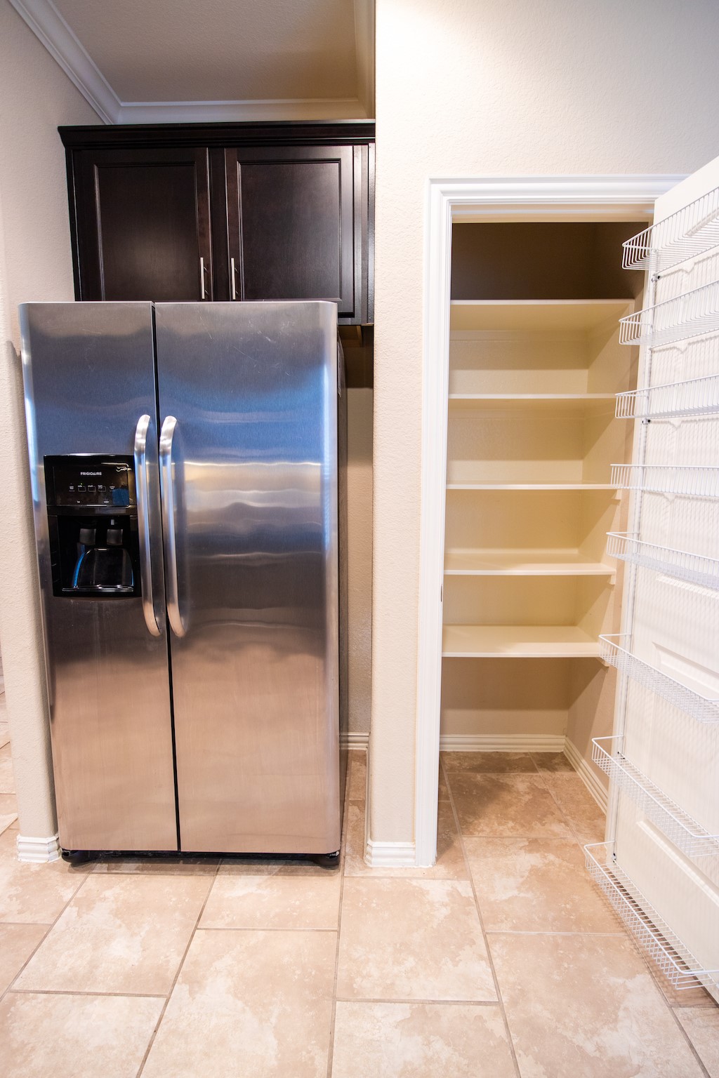 7042 Bristol Memorial Drive Spring, TX 77379 - Photo 6 of 21 a view of a refrigerator in kitchen and an empty room