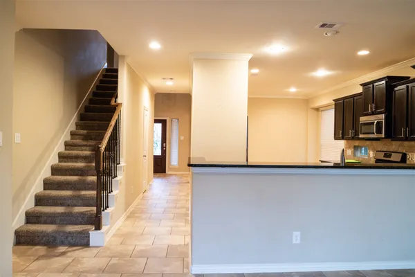 a view of a kitchen with furniture and staircase