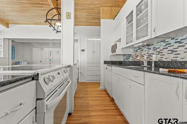 a kitchen with stainless steel appliances granite countertop a sink and cabinets