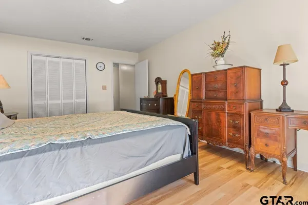 a bedroom with a bed and wooden floor