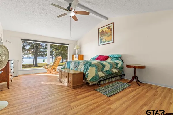 a bedroom with furniture and a wooden floor