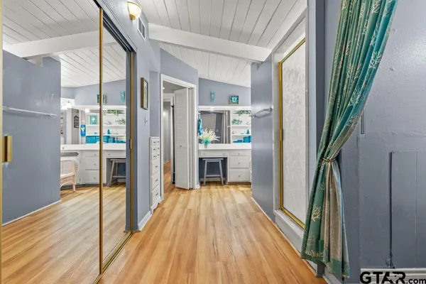 a view of a hallway view with wooden floor and staircase