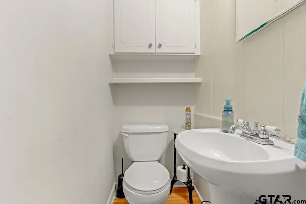 a bathroom with a sink a toilet and mirror
