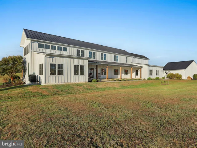 a front view of a house with a garden and yard