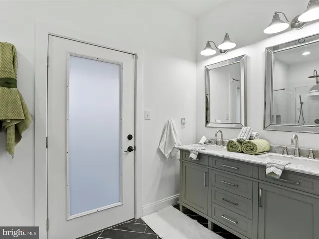 a bedroom with a bed and a mirror