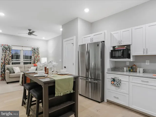 a room with table chairs and chandelier