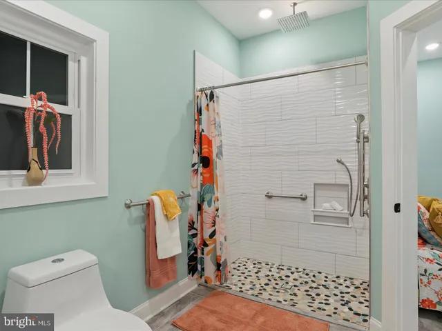 a view of a big house with a big yard and large trees