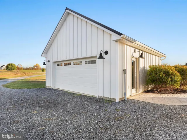 a view of house with a yard and a large tree center in it