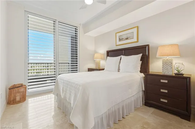 a bedroom with a bed and a lamp