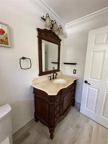a spacious bathroom with a granite countertop sink and a mirror