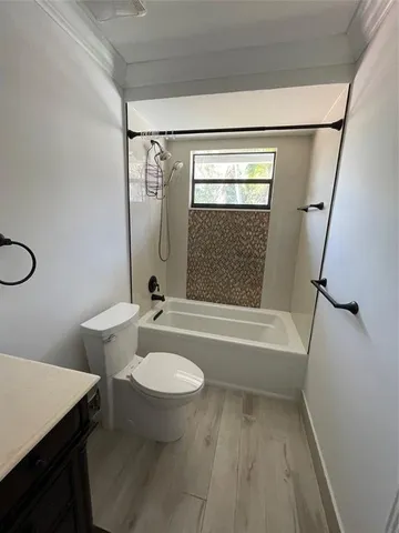 a bathroom with a sink a toilet a mirror and shower