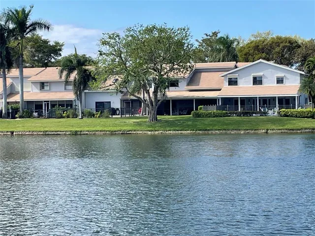 a view of house with outdoor space and lake view