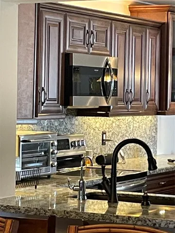 a kitchen with a stove and a microwave