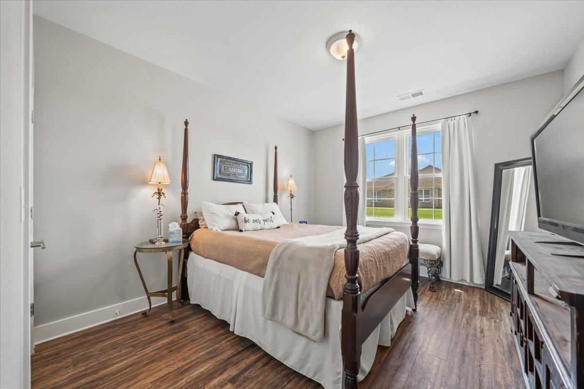 415 Abbey Road, Unit D Munford, TN 38058 - Photo 22 of 35 Bedroom featuring wood-finish flooring, light gray walls, white trim, and a ceiling-mounted light fixture