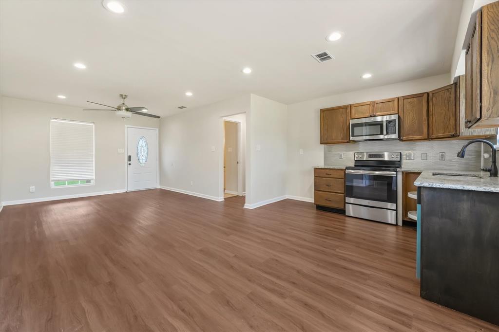 304 East Stone Road Wylie, TX 75098 - Photo 3 of 19 a view of kitchen with microwave and stove