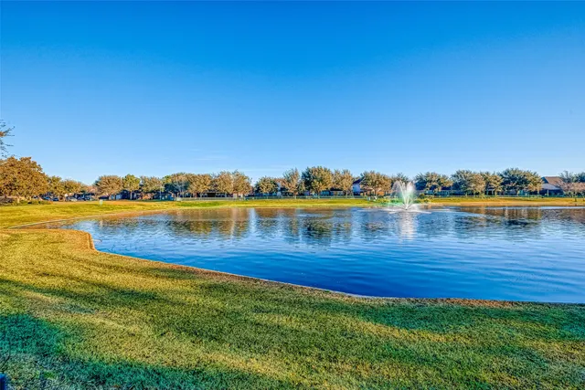 a view of a lake with houses in the back