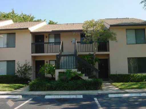 a front view of a house with plants