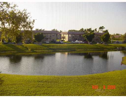 21943 Remsen Terrace, Unit 204C Boca Raton, FL 33433 - Photo 2 of 7 a view of a lake with a yard