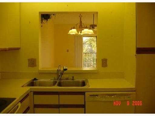 21943 Remsen Terrace, Unit 204C Boca Raton, FL 33433 - Photo 4 of 7 a bathroom with a sink and a mirror
