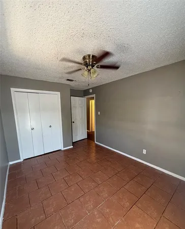 a view of a livingroom with a ceiling fan and window