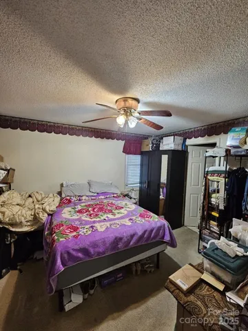 a bathroom with a toilet and a shower curtain