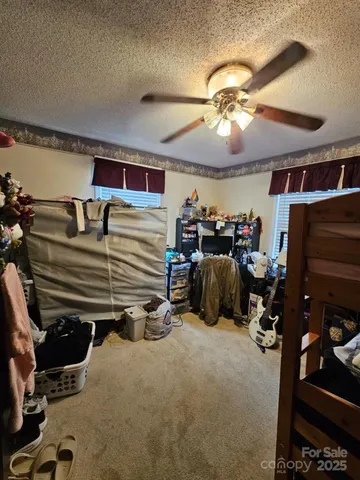 a bedroom with a bed and a tv