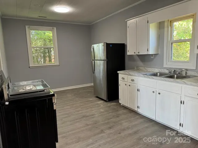 a kitchen with stainless steel appliances a refrigerator sink and cabinets