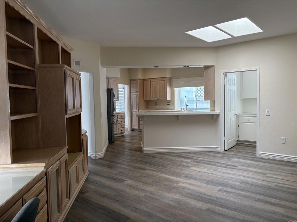 4143 Andros Way Oceanside, CA 92056 - Photo 11 of 34 a view of kitchen with refrigerator cabinets and wooden floor
