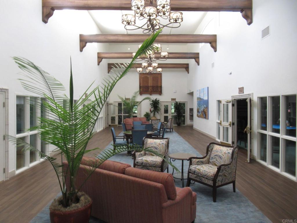 4143 Andros Way Oceanside, CA 92056 - Photo 31 of 34 a living room with furniture a chandelier and wooden floor