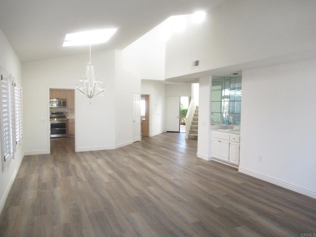 4143 Andros Way Oceanside, CA 92056 - Photo 9 of 34 a view of a big room with wooden floor and windows