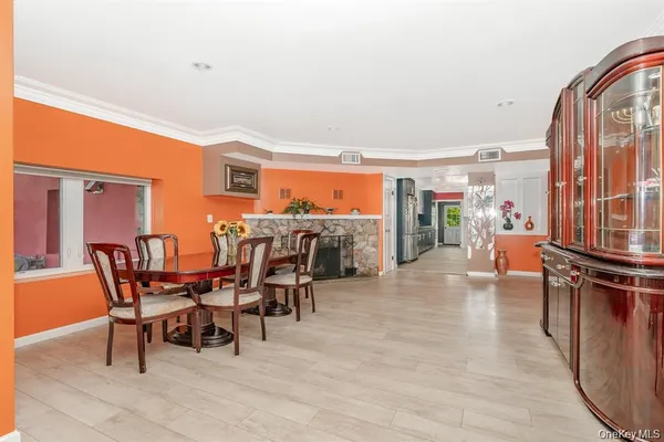 a dining room with furniture and a floor to ceiling window