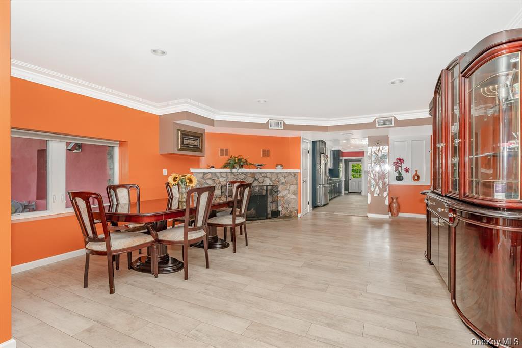 28 Riverside Avenue Amityville, NY 11701 - Photo 11 of 31 a dining room with furniture and a floor to ceiling window