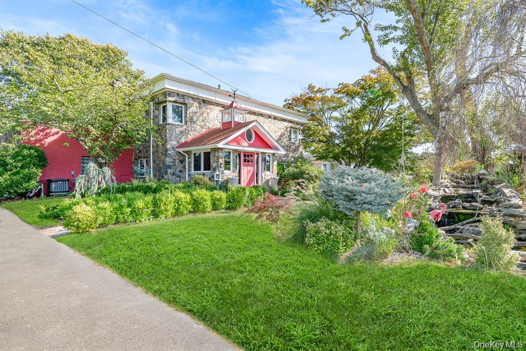 28 Riverside Avenue Amityville, NY 11701 - Photo 2 of 31 a view of a house with a yard and garden