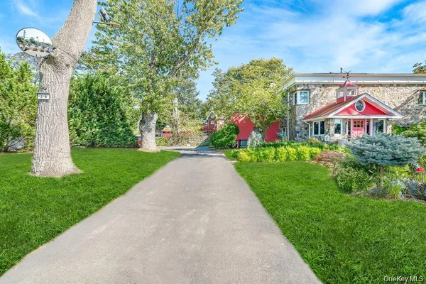 a front view of a house with a yard and fountain