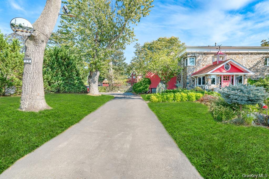 28 Riverside Avenue Amityville, NY 11701 - Photo 4 of 31 a front view of a house with a yard and fountain