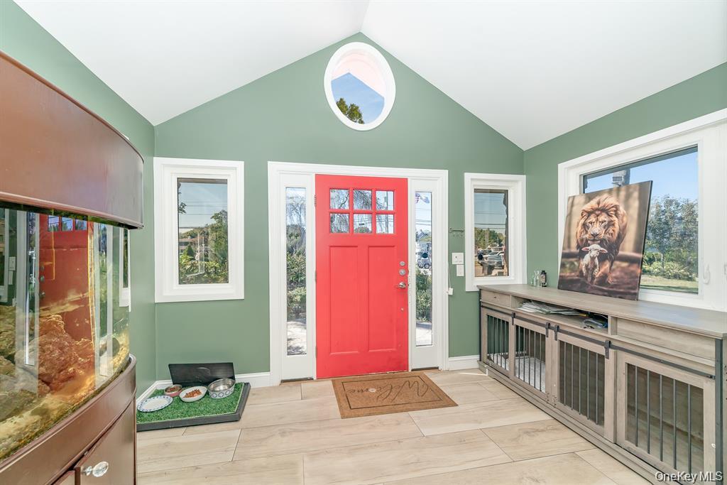 28 Riverside Avenue Amityville, NY 11701 - Photo 5 of 31 a kitchen with stainless steel appliances granite countertop a stove a sink and a microwave