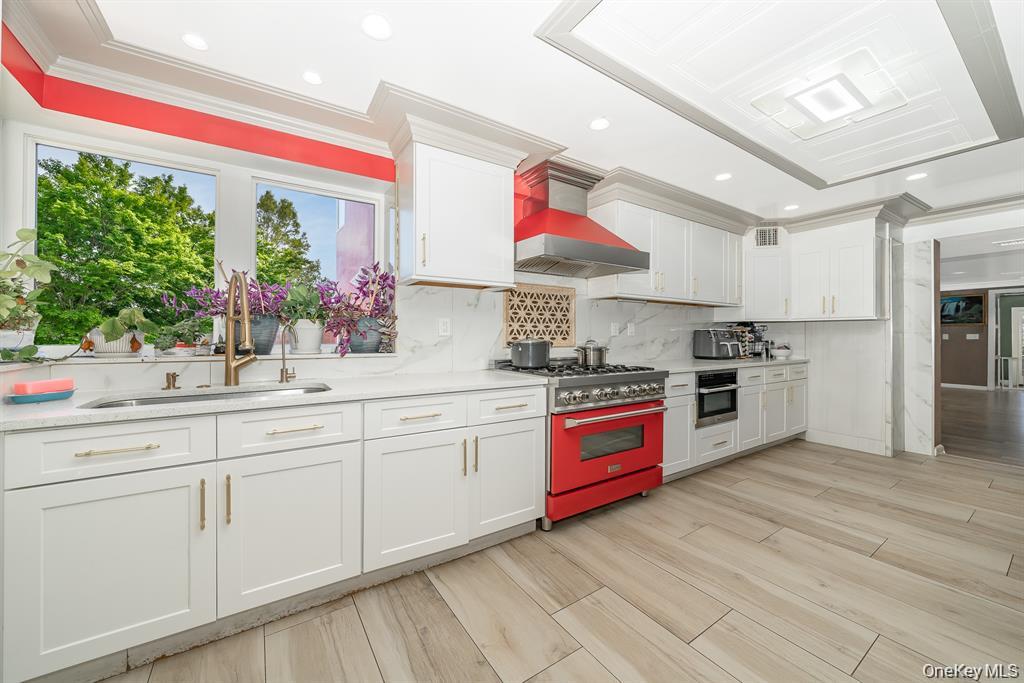 28 Riverside Avenue Amityville, NY 11701 - Photo 7 of 31 a kitchen with stainless steel appliances granite countertop a stove a sink and a refrigerator