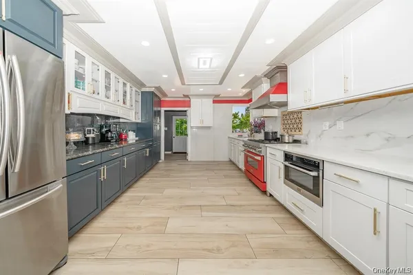 a kitchen with stainless steel appliances granite countertop lots of counter top space and cabinets