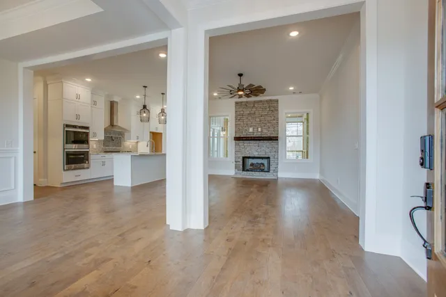 a view of kitchen with sink and refrigerator