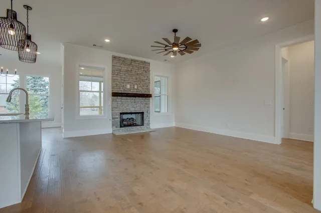 a view of an empty room with a fireplace and a window
