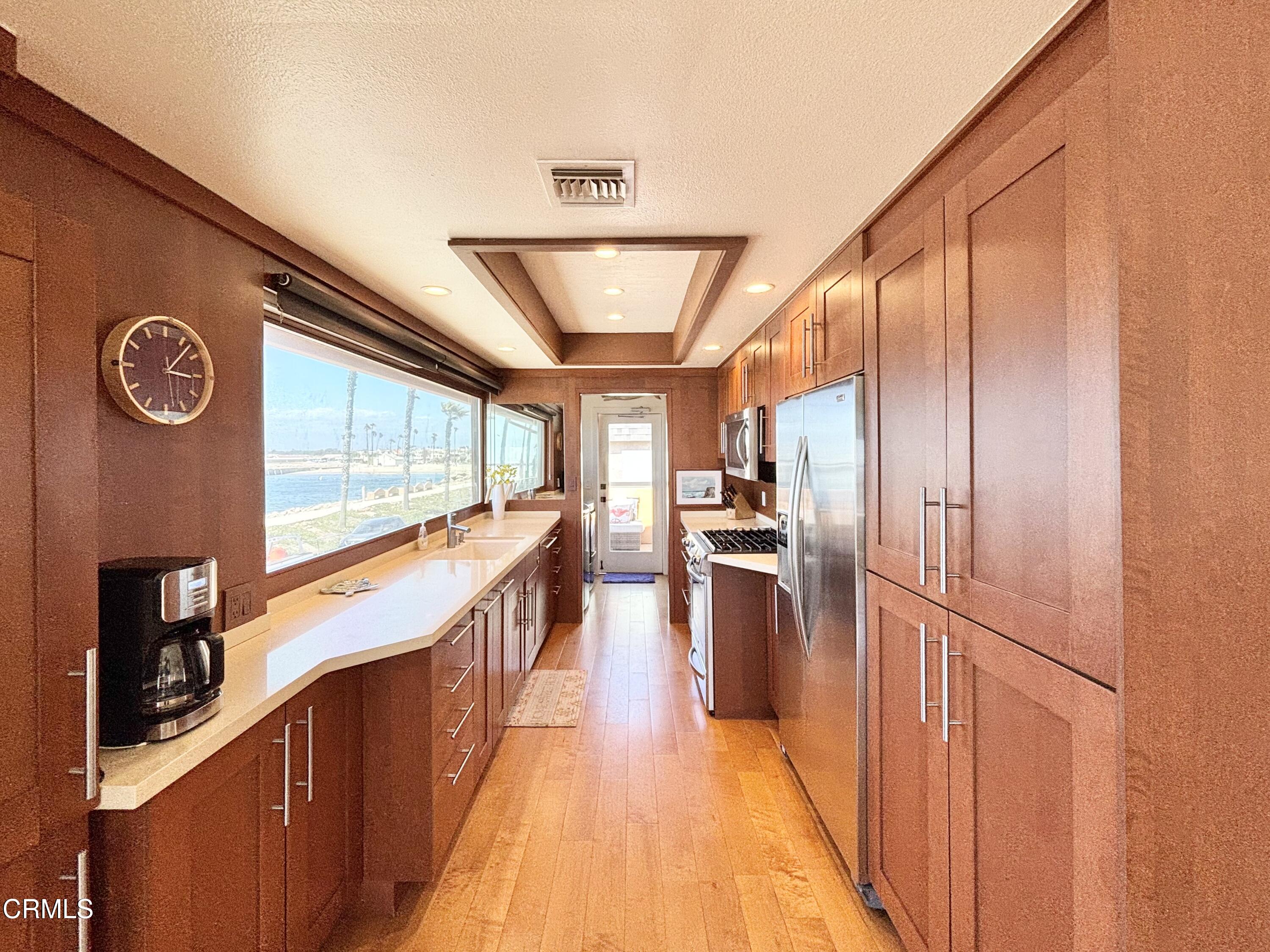 2524 Ocean Drive Oxnard, CA 93035 - Photo 4 of 28 a view of a hallway with wooden floor and furniture