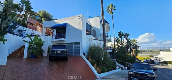 a view of a house with couches and potted plants