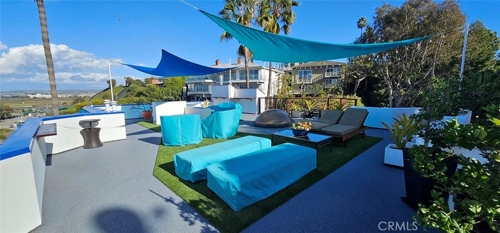 8109 Sinaloa Road Playa del Rey, CA 90293 - Photo 5 of 19 a view of a patio with couches table and chairs and potted plants