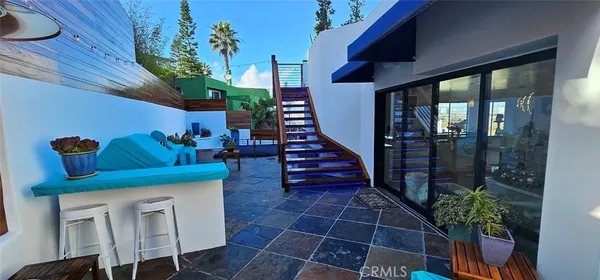 a view of a dining room with furniture large windows and wooden floor